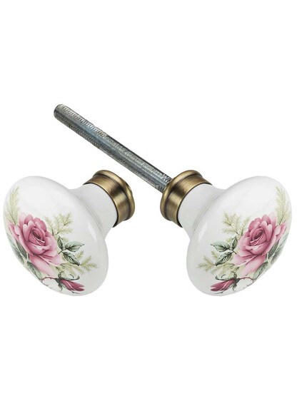 Pair of Rose Porcelain Knobs in Antique Brass.